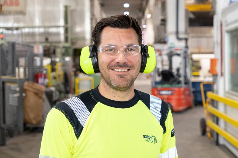 Man in protective and visibility clothing in factory